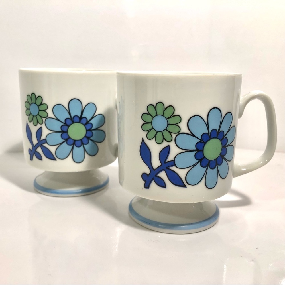 2 Vintage floral pedestal mugs, white with blue and green flowers. Japan.